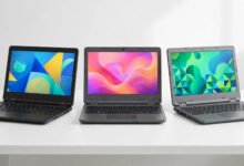 Three budget laptops side by side on a clean desk