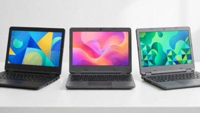 Three budget laptops side by side on a clean desk